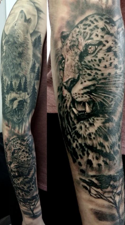 Tatouages réalistes représentant un loup, un ours et un léopard, créations de Lucy Célestattoo
